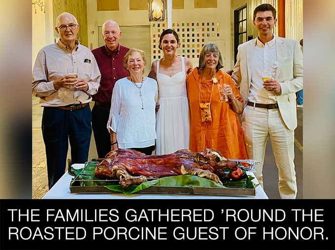 The families gathered 'round the porcine guest of honor.